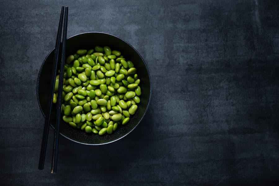 Bowl of edamame beans with chopsticks