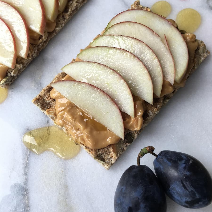 apple slices with peanut butter on a cracker healthy snack for kids