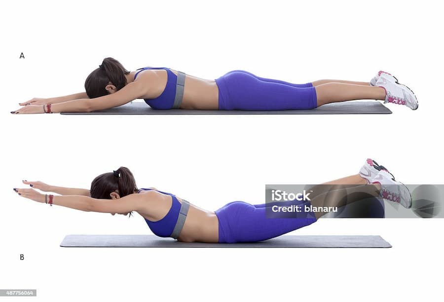 woman doing superman exercise for back at home