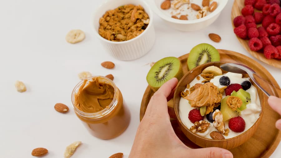 Healthy yogurt bowl with fresh fruit and granola for a protein snack