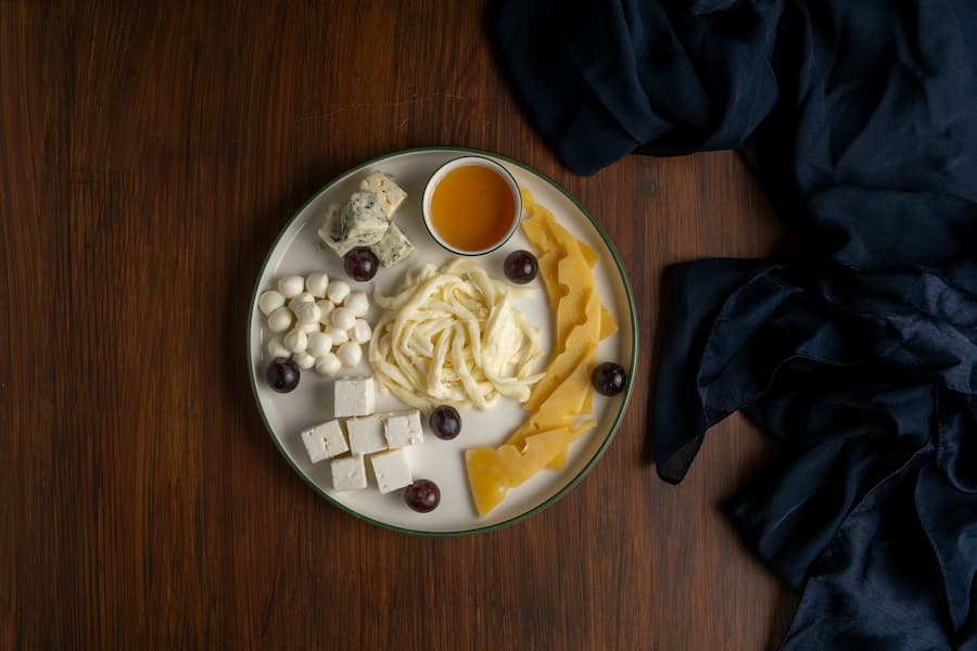 Cheese platter with string cheese, mozzarella balls, feta cubes and sliced cheese