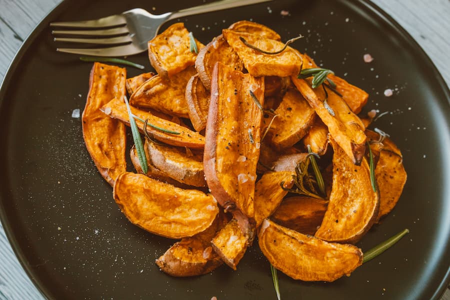 baked sweet potato wedges with rosemary on a plate healthy snack for kids