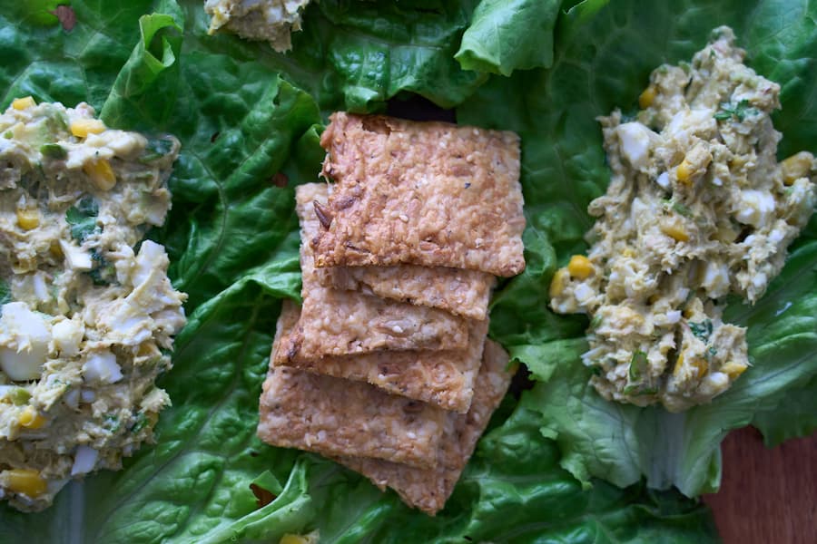 Tuna salad on lettuce leaves served with whole-grain seeded crackers