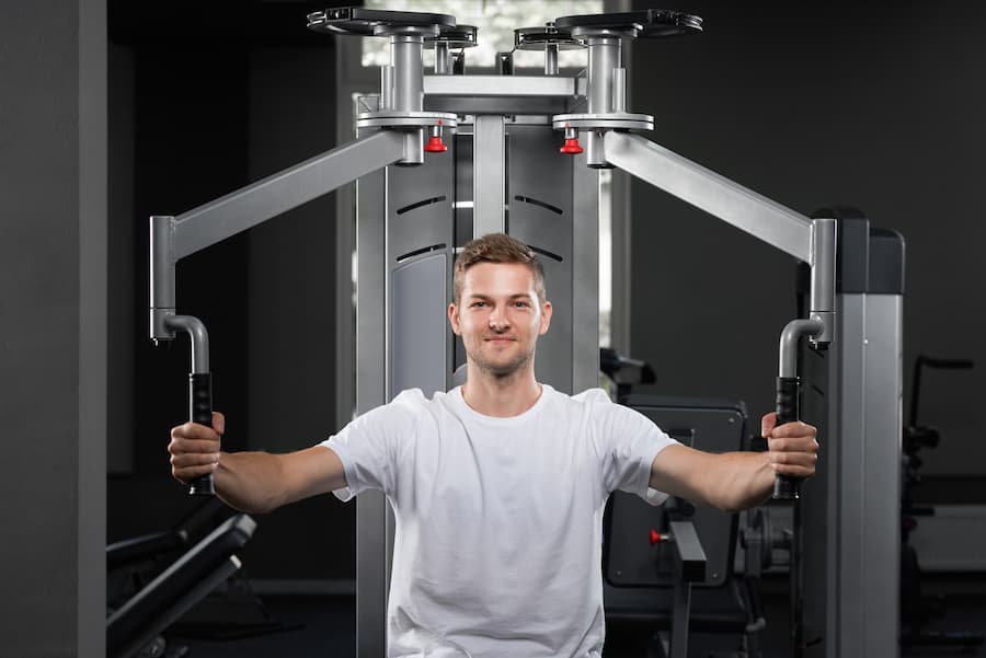 Man performing a chest press exercise on a gym machine