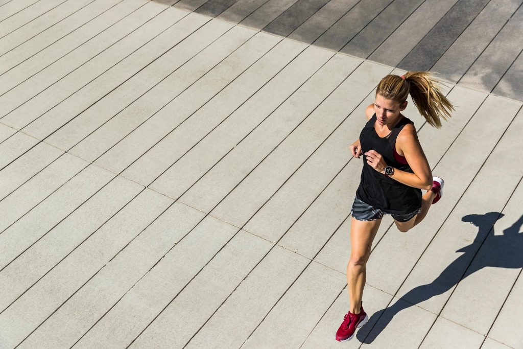 Woman running outdoors for fitness and exercise
