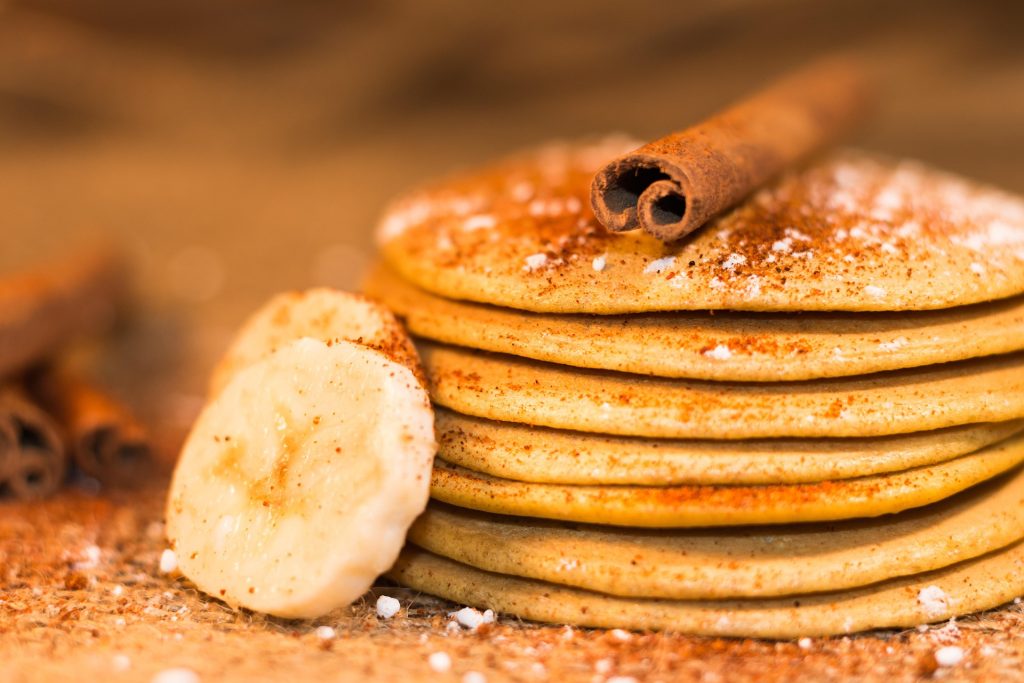 stack of banana oat pancakes with banana slice and cinnamon healthy snack for kids