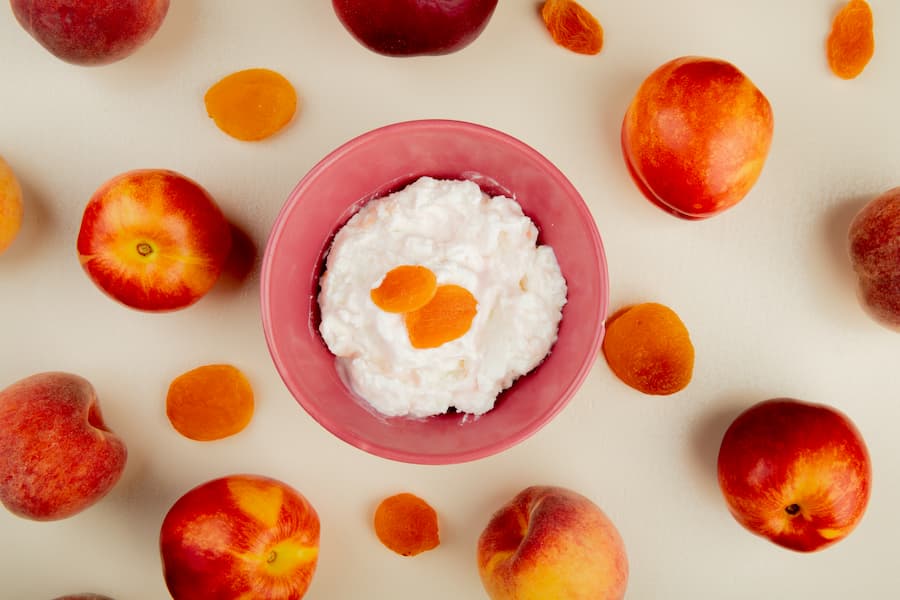 Cottage cheese with fresh peach slices in a pink bowl