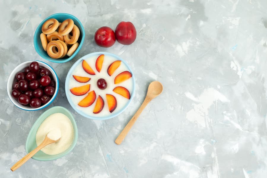 healthy toddler snacks with yogurt topped with sliced peaches and crackers
